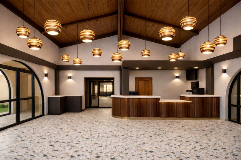Hotel lobby with wood reception desk and gold pendant lights